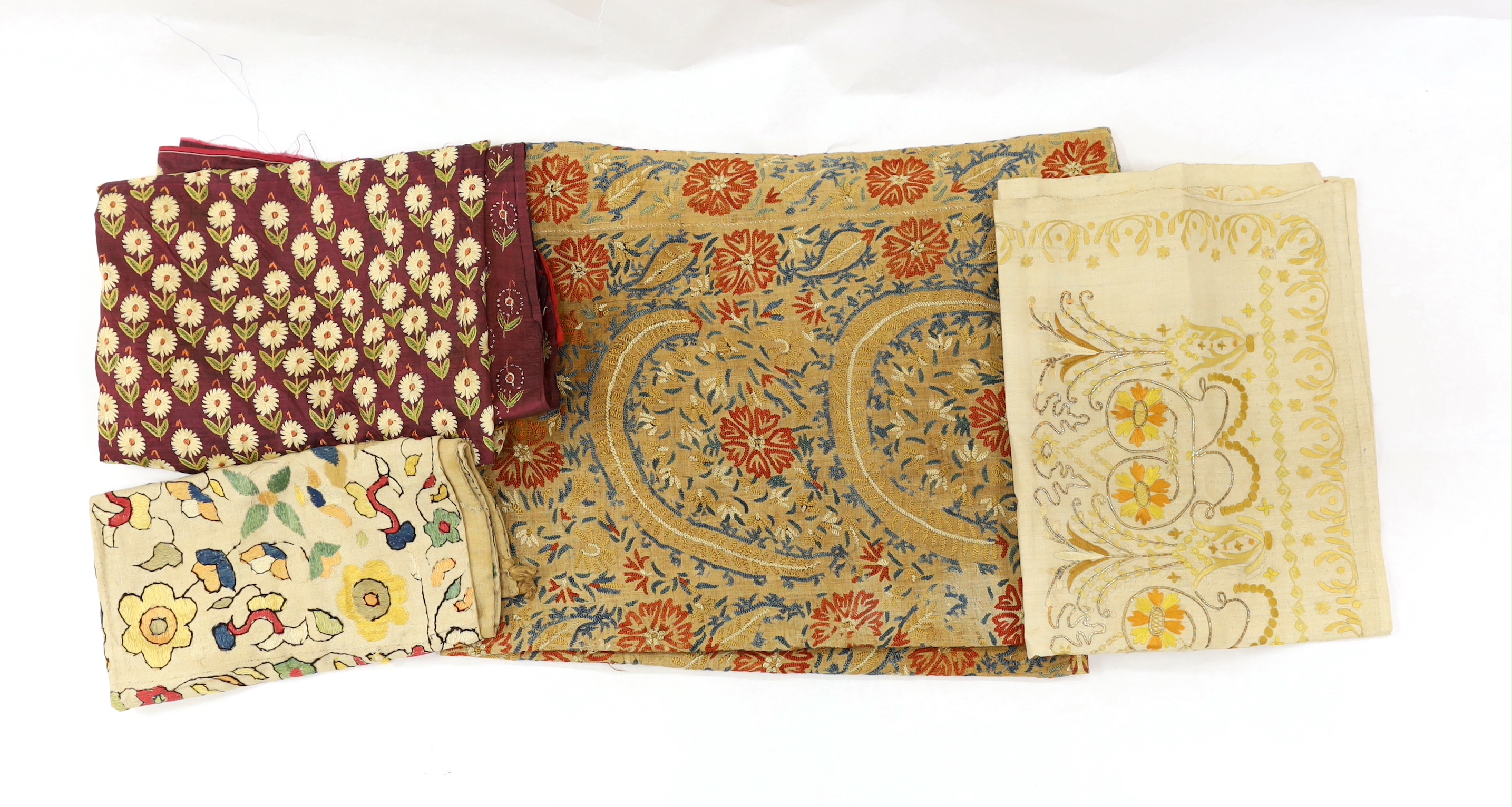 An Indian embroidered panel, a small linen embroidered panel possibly Turkish, a maroon silk length of fabric, heavily embroidered with all over flower motifs, possibly cut from a sari, together with a handwoven linen em